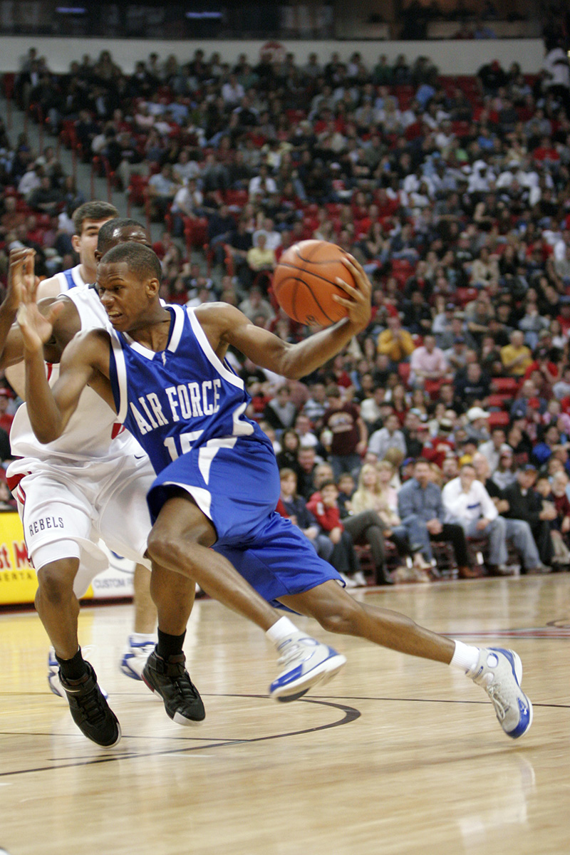 Color photograph of college basketball game in 2005 showing a close-up action shot of the player mid-dribble